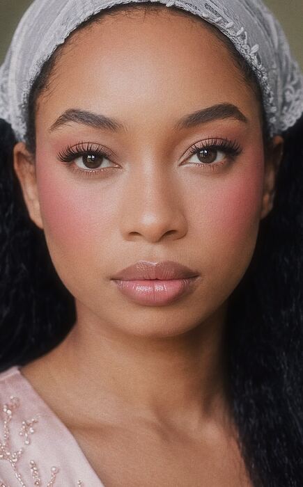 Portrait with rose-toned makeup and a white headband